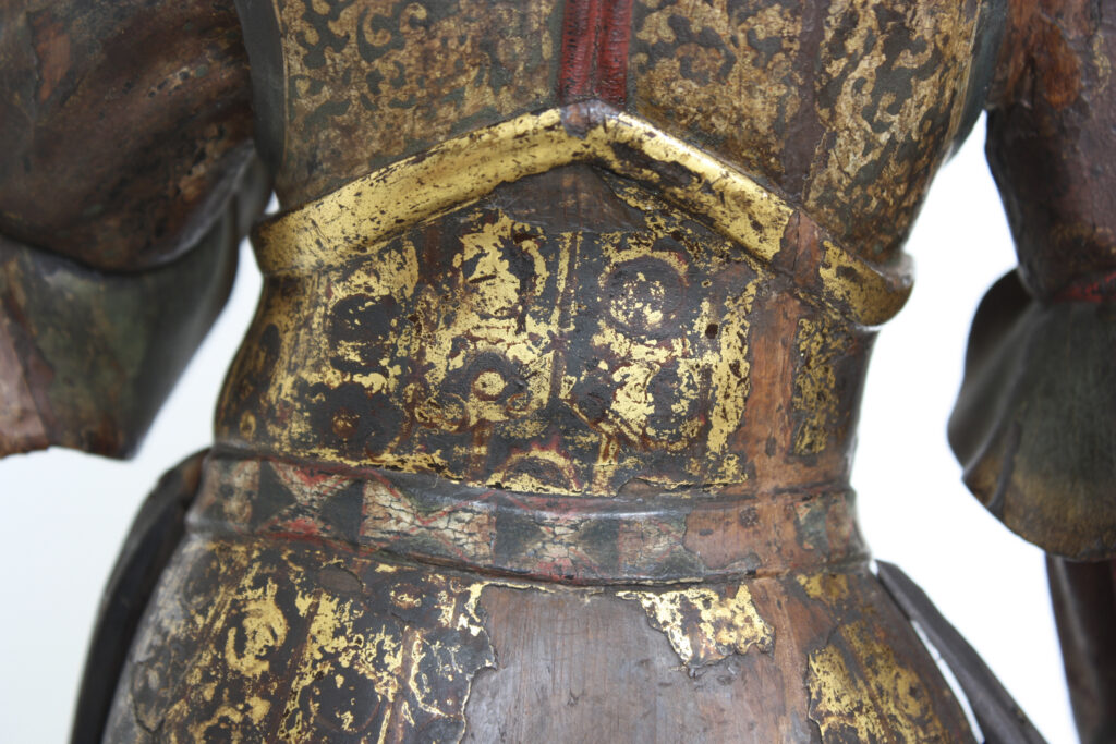 Dettaglio del volto e della policromia di un guardiano del Buddha Nyorai.